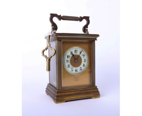 A brass carriage clock, Dent of London, with key, height 13cm.