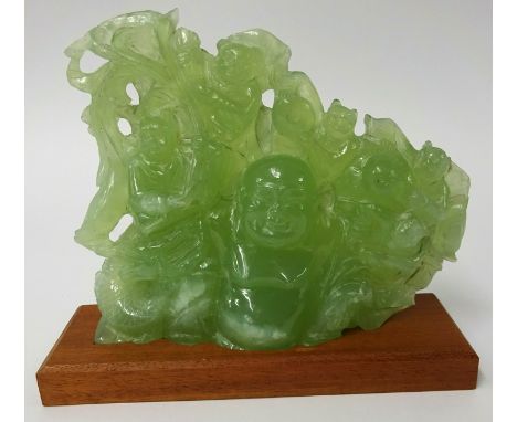 A carved 'jade' group depicting Buddha and laughing monkeys, height 18cm, width 22cm on later stand.