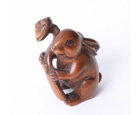 A carved wood netsuke in a form of a hair, height 40mm