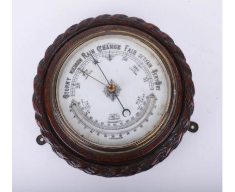 A traditional circular wall barometer.