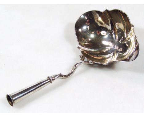 A George II silver ladle, with leaf shaped bowl and turned scroll handle, indistinct maker's mark, London 1737, 18cm wide, 2o