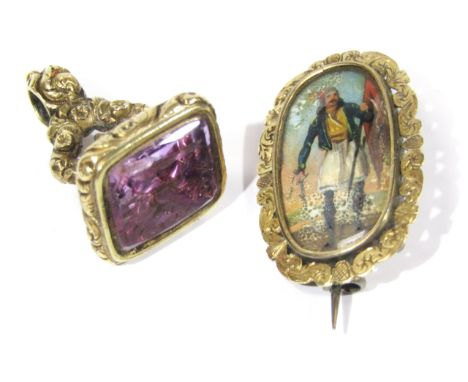 An early 19thC portrait brooch, the soldier painted with sword and flag, set in yellow and white metal mounts, 3.5cm high, an
