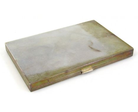 A George VI silver gilt cigarette case, by W.H. Manton Ltd, of rectangular outline with engine turned exterior and plain inte