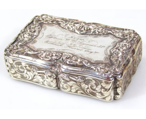 A Victorian silver and silver gilt snuff box, by Nathaniel Mills, of shaped rectangular outline, heavily embossed with scroll