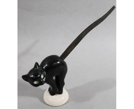 An early Goebel pottery figure of a cat, in standing pose on domed base, predominantly in black and white with elongated wood