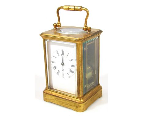 An early 20thC brass cased carriage clock, with 6cm wide Roman numeric dial and pierced orb pointers, in a five part glazed c
