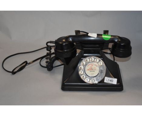 An early plastic rotary dial telephone.