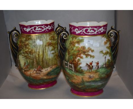 Two Edwardian twin handled vases, of ovoid form, having hand painted hunting scenes to cerise ground with gilt heightening to