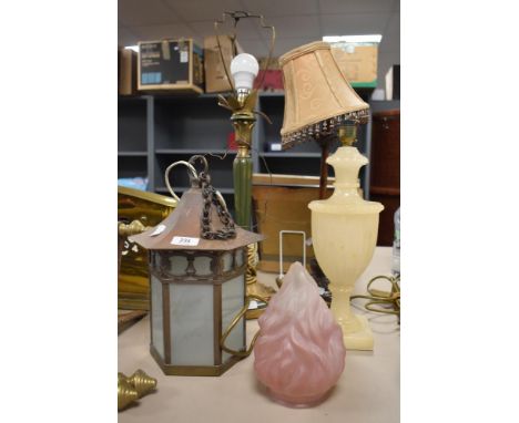 An Alabaster classical urn form table lamp, a late 19th Century table lamp with tasselled shade, another table lamp, a late 1