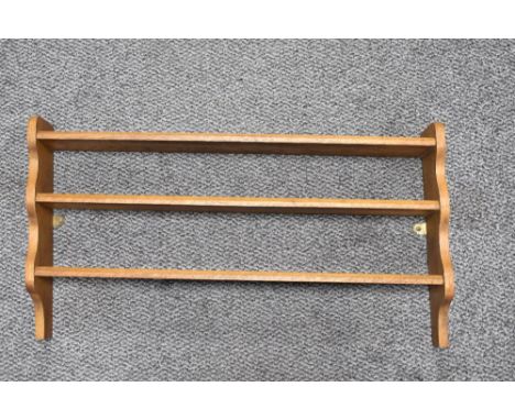 An oak open backed three tiered hanging shelf rack, measuring 38cm tall and 68cm long