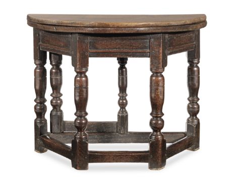 A James I joined oak fold-over table, circa 1620 and laterHaving an historically associated half-round fold-over top, the goo