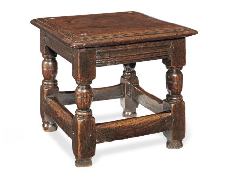 A rare Charles I padouk and oak low joint stool, circa 1630Having a near-square single-piece padouk top with broad multiple-r