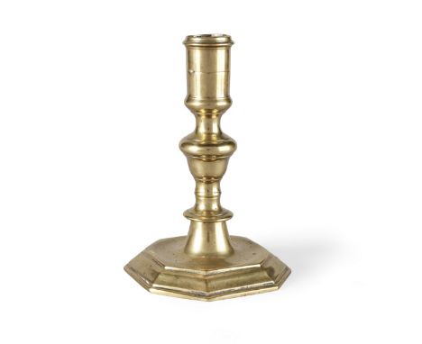 A William &amp; Mary brass candlestick, circa 1690The socket with moulded rim, the stem with acorn knop above a blade, on a s