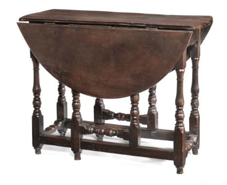 A William &amp; Mary joined solid yew-wood gateleg table, circa 1700Having an oval drop-leaf top, each flap formed from a sin