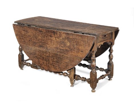 A Charles II joined oak dining gateleg table, possibly Yorkshire, circa 1680Having a thick oval drop-leaf top, a single end-f