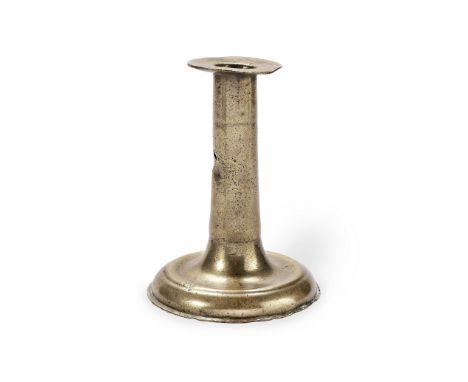 A small mid-17th century brass alloy trumpet-based candlestick, England, circa 1650-80The socket with broad flange, raised on