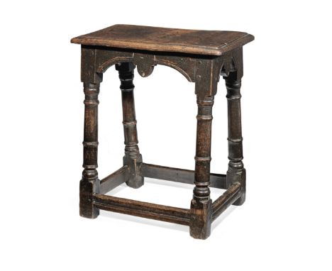 An interesting James I oak joint stool, Gloucestershire, circa 1620Having an ovolo edge moulded top, and rare arch-shaped rai