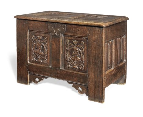 A small 16th century joined oak coffer, French, circa 1530-50Having a twin-panelled hinged lid, the front with two carved Rom