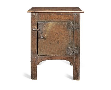 A small Elizabeth I joined oak standing 'hutch', circa 1580The boarded top with ovolo-moulded edge, the single board door fra