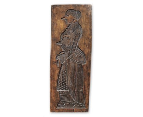 A very large 19th century beech gingerbread mouldCarved to one side with a lady in a fashionable costume, a dog beneath her a