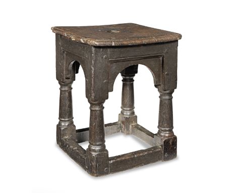 An Elizabeth I small low 'joint stool', circa 1600Possibly formed from a bed-post, the near-square ovolo-moulded seat with ci