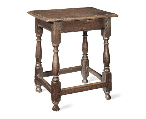 A Queen Anne joined oak table-stool, circa 1710The single-piece ovolo-moulded top with chamfered under-edge, plain frieze rai