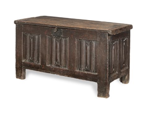 A Henry VIII joined oak linenfold-carved coffer, circa 1540Having a thick twin-boarded and end-cleated hinged lid, three line