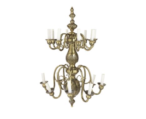 A large brass sixteen-branch chandelierWith two graduated tiers of eight scrolling candle-branches terminating in leaf-decora