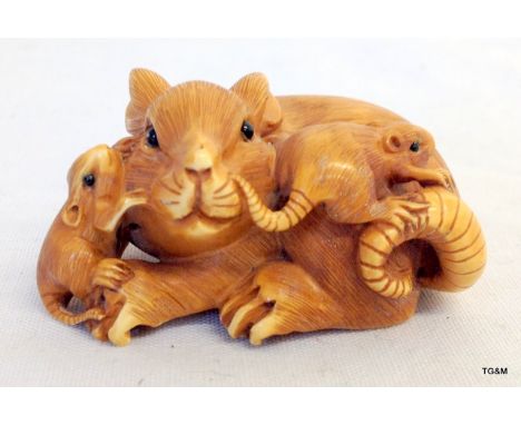 An ivory or bone Netsuke depicting a group of rats