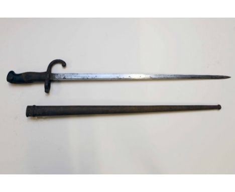 A French model 1874 Gras sword bayonet in scabbard manufactured at the St. Etienne arsenal in 1877