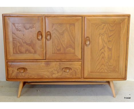 A Ercol blonde sideboard on raised trestle supports 82 x 114 x 44cm