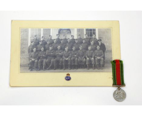 A WW2 Home Guard platoon photograph 13 x 8 inches overall with a Defence Medal and a gilt & enamel Home Guard lapel badge