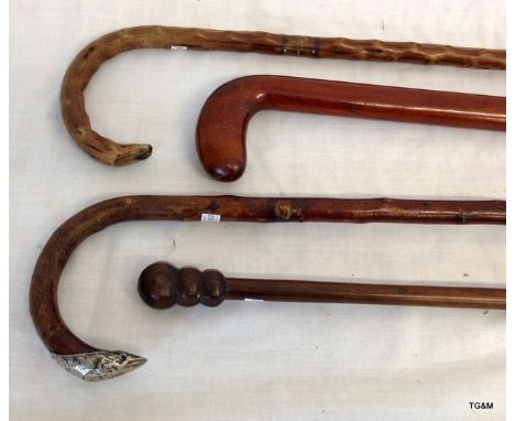 A silver topped walking stick and 3 other various walking sticks 