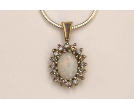 A white gold and opal pendant necklace