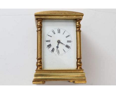 A miniature brass gilt carriage clock made in France. 8cm tall