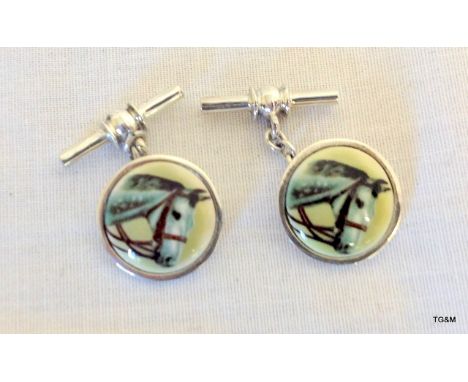 A pair of silver and enamel cufflinks