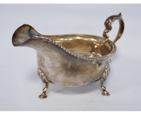 George V silver sauce boat in the Georgian taste, hallmarks for Walker &amp; Hall, Sheffield 1931-32, with scroll handle and 