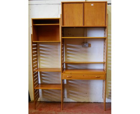Teak Ladderax unit, c. 1960s, with sliding doors to the top above open shelving and a drawer, flanked by further open shelvin