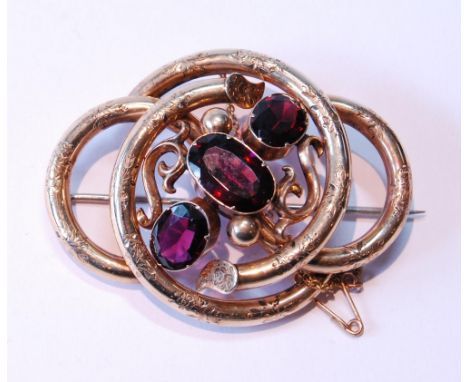 Victorian gold-cased whorl brooch with three almandine garnets. 
