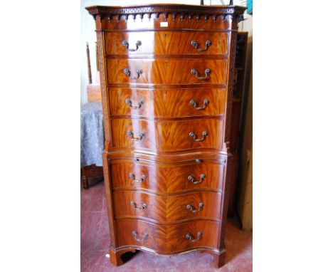 In the Manner of Thomas Chippendale Mahogany serpentine chest on chest with Greek key decoration to the top above turned fini