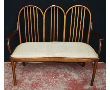 Jacob & Josef (J & J ) Kohn of Austria Bentwood settee with triple wheel frame and stick back, later upholstery to the seat, 