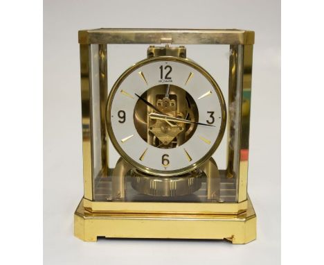 A Jaeger Le Couture mantel clock, in brass case with bevelled glass on four sides, with Atmos movement, case 21x24x16cms deep