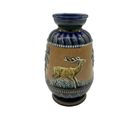 Glossy ceramic vase with a cobalt blue base and top with engraved leaf designs. The central band is decorated with reliefs of