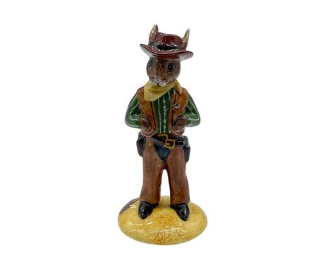 Hand decorated porcelain bunny figure of a rancher in a green shirt with white stripes, yellow neckerchief, and brown hat. A 