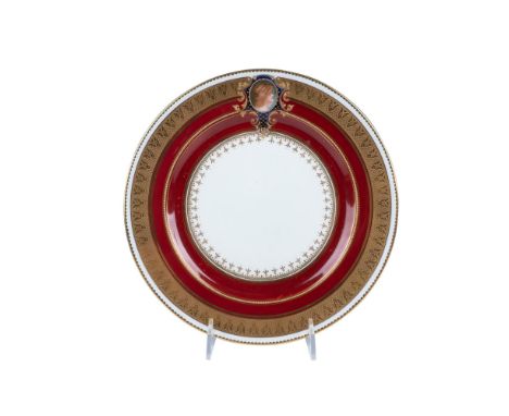 Regal ruby red and gilt hand-painted dinner plate with a vibrant collar. Small woman's portrait at the top. Stamped Charles R