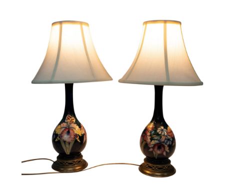 A gorgeous, matched pair of Moorcroft lamps with Orchid pattern on blue background. Mounted on Walter Moorcroft. MSLC 4468 ca