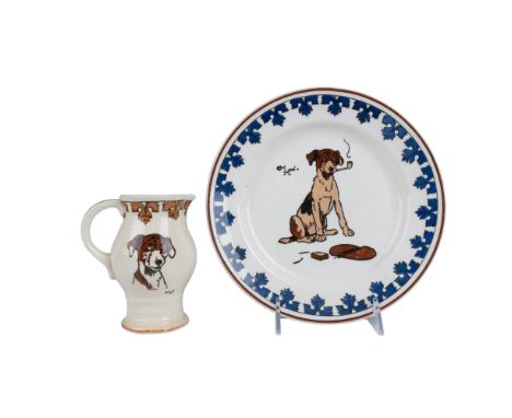 Decorative plate features a dog smoking a pipe encircled by a blue stylized foliate border. It measures 9.5"dia. The pitcher 