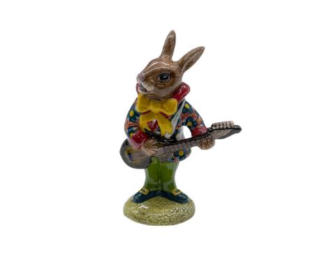 Mr. Bunnybeat Strumming. Rare hand decorated porcelain bunny figure playing a guitar. Mr. Bunnybeat is shown dark pink jacket