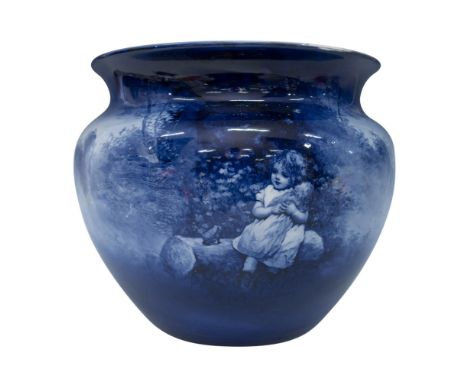 A planter depicting a girl with her doll in a country landscape, finished in the flow blue technique, which creates a soft, m
