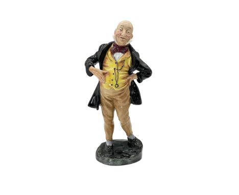 This hand painted bone china figurine is part of the Dickens series and depicts Mr. Micawber with a yellow and orange waist c